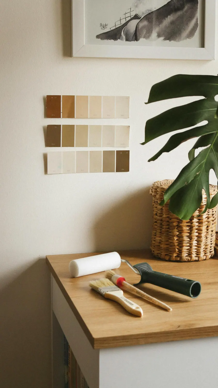 Interior styling scene with paint swatches, brushes, and color-planning tools arranged for a project kickoff.