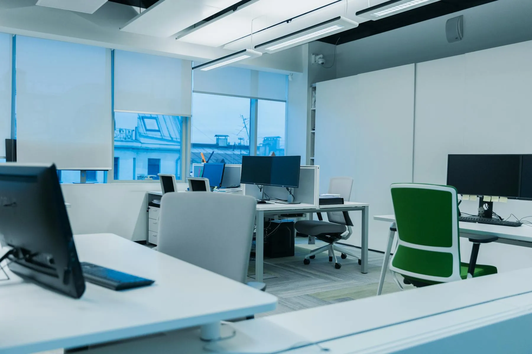 Freshly painted office interior with large windows.